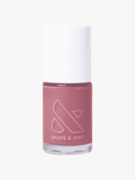 A bottle of Olive & June Long Lasting Polish in Fig Ranch on a light gray background