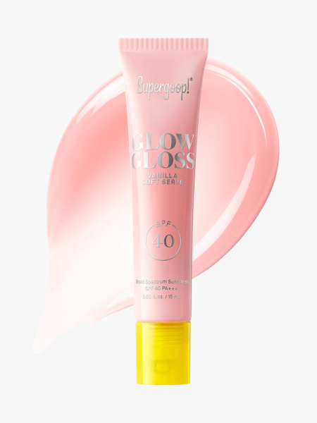 Supergoop Glow Gloss Spf 40 Lip Balm tube of pink lip gloss with yellow cap on light gray background