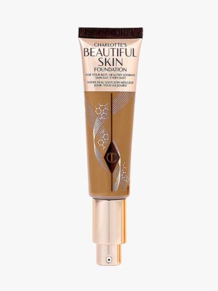 Charlotte Tilbury Beautiful Skin Foundation rose gold and transparent tube of foundation on light gray background